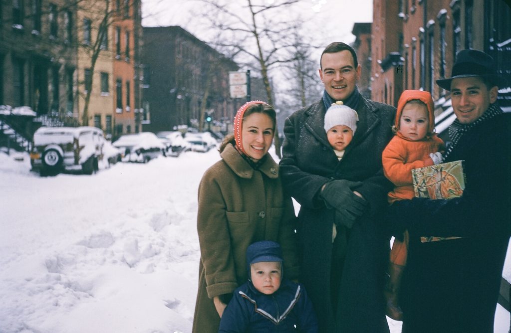 Maryann, Clovis, and Jack Pancoast with John, Star (in Jack’s arms), and Mary Elizabeth in Clovis’s coat, in front of Henry Street, early 1958.