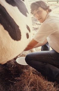 Ben is milking Rosie, our cow.