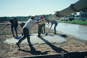 Tennis court cement slab being poured.
