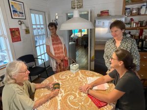 Casita - Kitchen - This is me, Mary Elizabeth, Catherine, and Virginia, gathering after Clovis’s funeral in October 2021 You can see the door to the screen porch, and the double doors to the bedroom, and behind Catherine the refrigerator.