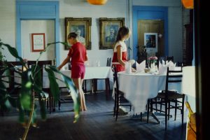 Setting tables in the Country Place Restaurant dining room 1982