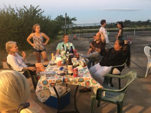 Christy, Mallory (standing), John, Ben, Sandi, and standing behind - Mary Elizabeth and Kristin. The tennis court could be used for picnics and parties, using folding tables and plastic chairs. You can see the clips that keep the tablecloth from blowing away.