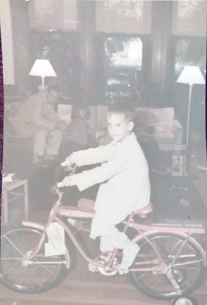Ben on bicycle in living room at Christmas 1967