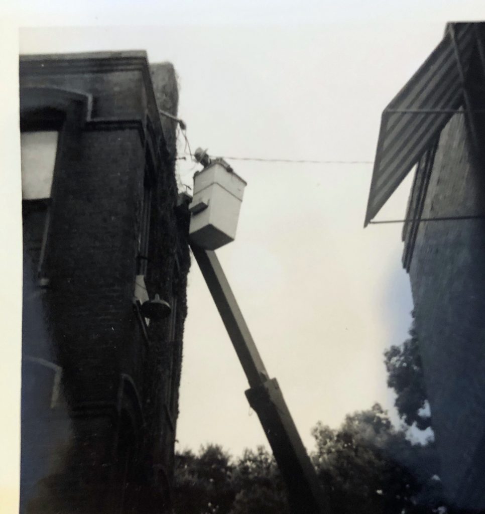 Electrical worker in basket