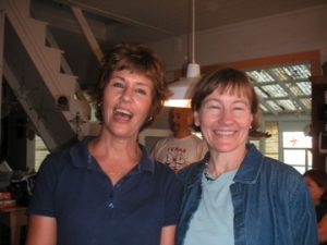 Mary Elizabeth and Catherine in the kitchen. You can see the stair that goes upstairs and the greenhouse roof behind them.