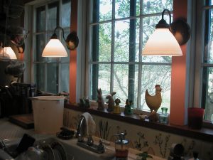 The kitchen sink and tile backsplash, and the window looking out to the garden.