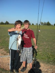 Ruben and Connor with a fish they caught in the pond