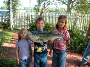 The children with a fish they caught in the pond