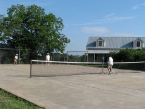 Lenny, Clovis, and John on the tennis court, the 500 dollar house in the background to the right.